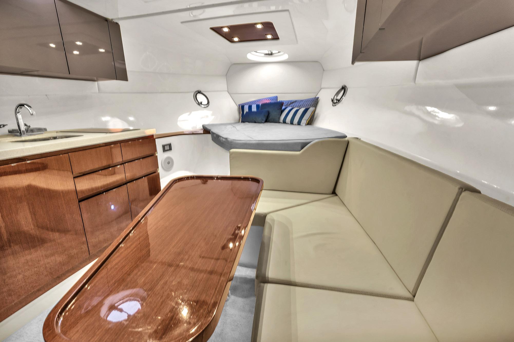 Luxurious interior of 2023 Schaefer 375 yacht with modern seating and kitchenette.