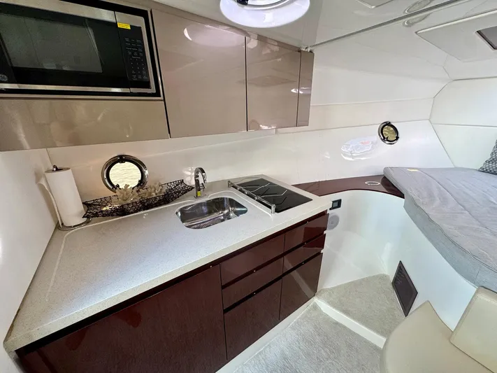 Dream Big Yacht Photos Pics Modern Schaefer 375 yacht interior with kitchenette, sink, and bed, 2023 model.