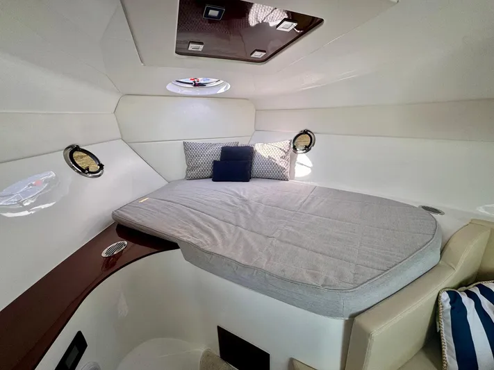 Dream Big Yacht Photos Pics 2023 Schaefer 375 yacht cabin with cozy bed, portholes, and modern interior design.