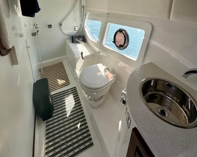 Dream Big Yacht Photos Pics Modern bathroom in 2023 Schaefer 375 yacht with toilet, sink, and porthole window.