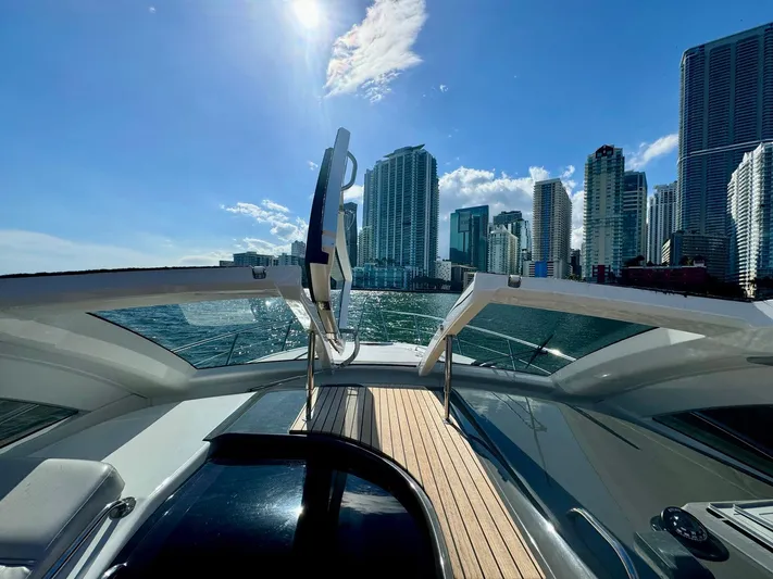 Dream Big Yacht Photos Pics Schaefer 375 yacht cruising near city skyline under clear blue sky, 2023 model.