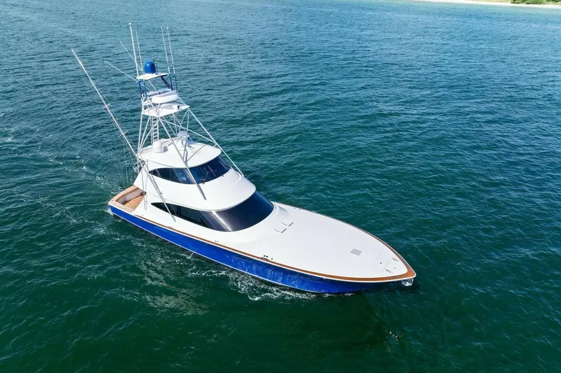 Backlash Yacht Photos Pics 2023 Viking 72 Enclosed Bridge yacht cruising on open water.