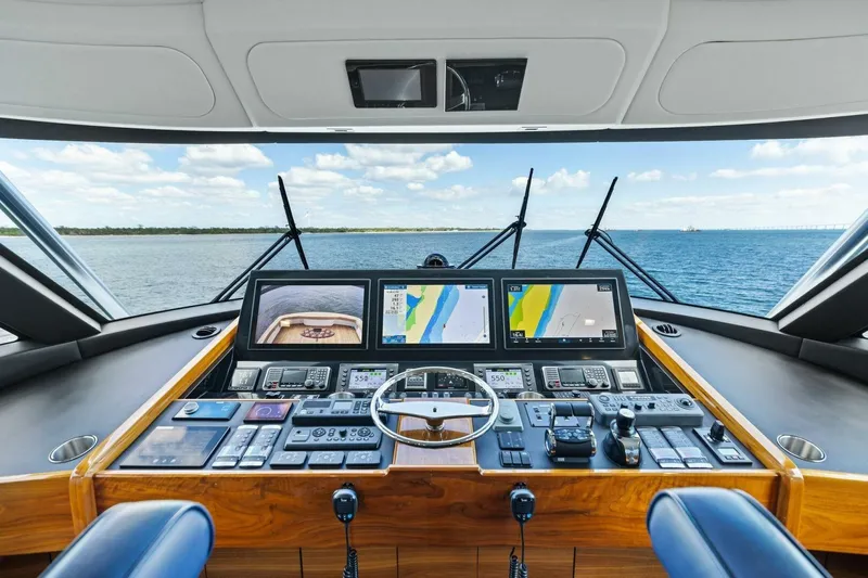 Backlash Yacht Photos Pics 2023 Viking 72 Enclosed Bridge yacht helm with advanced navigation systems and ocean view.