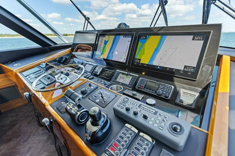 Backlash Yacht Photos Pics 2023 Viking 72 Enclosed Bridge helm with advanced navigation displays and controls.
