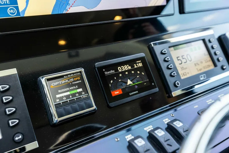 Backlash Yacht Photos Pics Control panel of 2023 Viking 72 Enclosed Bridge yacht with navigation displays.