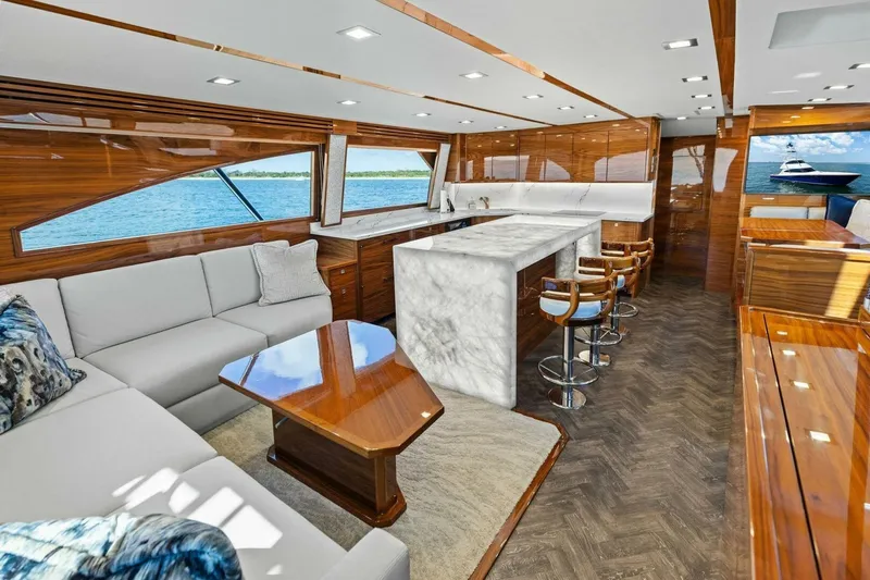 Backlash Yacht Photos Pics Luxurious interior of 2023 Viking 72 Enclosed Bridge yacht with elegant wood finishes.