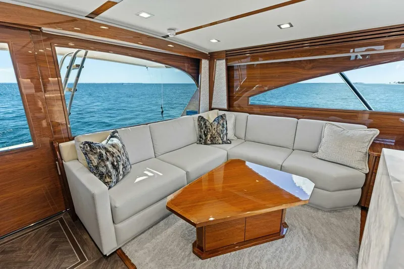 Backlash Yacht Photos Pics Luxurious interior of 2023 Viking 72 Enclosed Bridge yacht with ocean view.