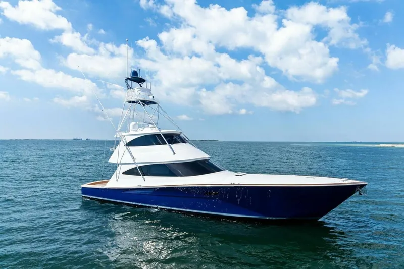 Backlash Yacht Photos Pics 2023 Viking 72 Enclosed Bridge yacht on open sea under blue sky.