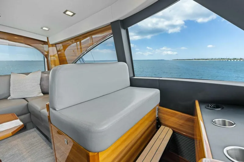 Backlash Yacht Photos Pics Luxurious interior of 2023 Viking 72 Enclosed Bridge yacht with ocean view.