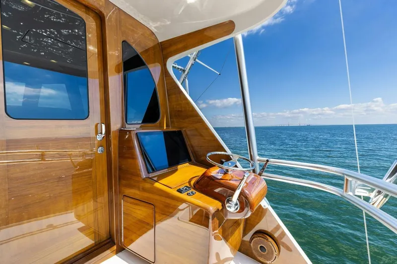 Backlash Yacht Photos Pics 2023 Viking 72 Enclosed Bridge yacht helm with ocean view.
