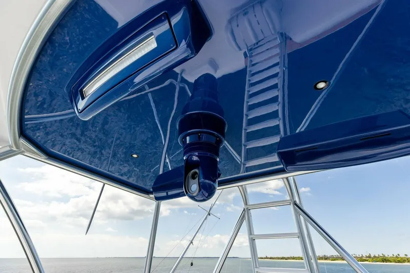 Backlash Yacht Photos Pics 2023 Viking 72 Enclosed Bridge yacht with sleek blue ceiling and ladder.