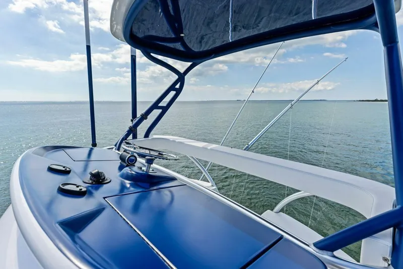 Backlash Yacht Photos Pics 2023 Viking 72 Enclosed Bridge yacht helm with ocean view and clear sky.