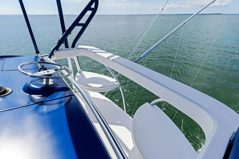 Backlash Yacht Photos Pics 2023 Viking 72 Enclosed Bridge yacht helm with ocean view.