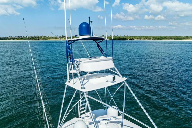 Backlash Yacht Photos Pics 2023 Viking 72 Enclosed Bridge yacht on calm ocean with clear sky.