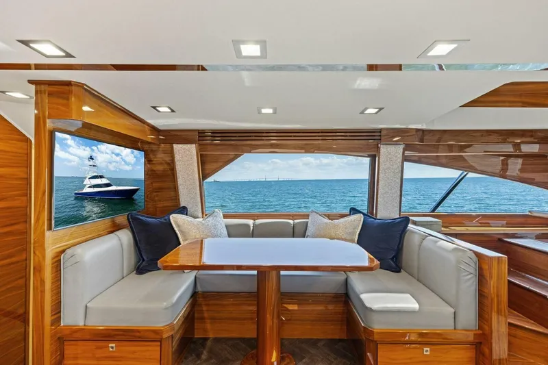 Backlash Yacht Photos Pics Luxurious interior of 2023 Viking 72 Enclosed Bridge yacht with ocean view.