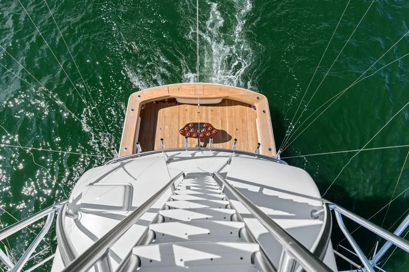 Backlash Yacht Photos Pics Aerial view of 2023 Viking 72 Enclosed Bridge yacht on green water.