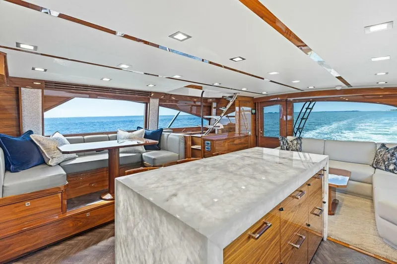 Backlash Yacht Photos Pics Luxurious interior of 2023 Viking 72 Enclosed Bridge yacht with ocean view.