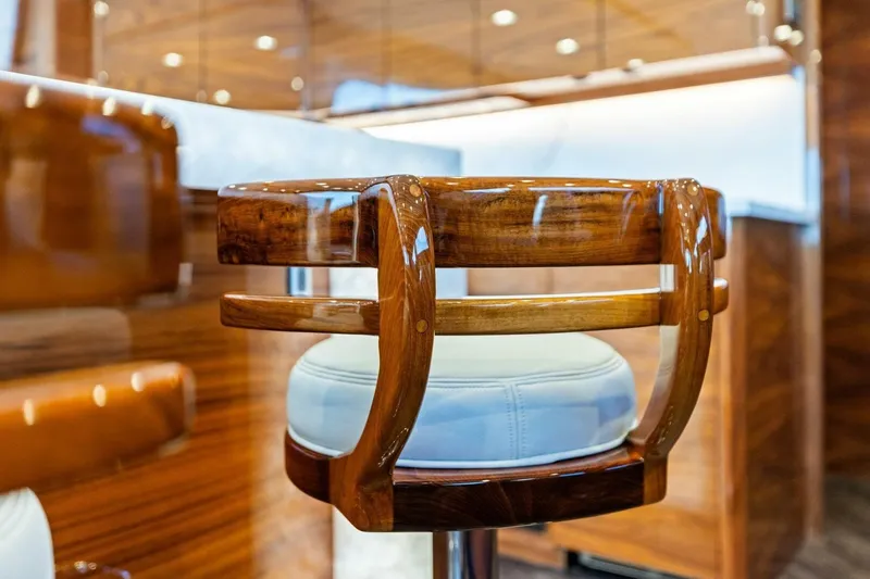 Backlash Yacht Photos Pics Luxurious wooden chair in 2023 Viking 72 Enclosed Bridge yacht interior.