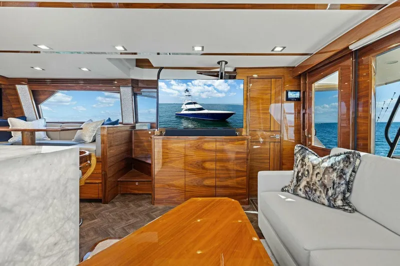 Backlash Yacht Photos Pics Luxurious interior of 2023 Viking 72 Enclosed Bridge yacht with elegant wood finishes.