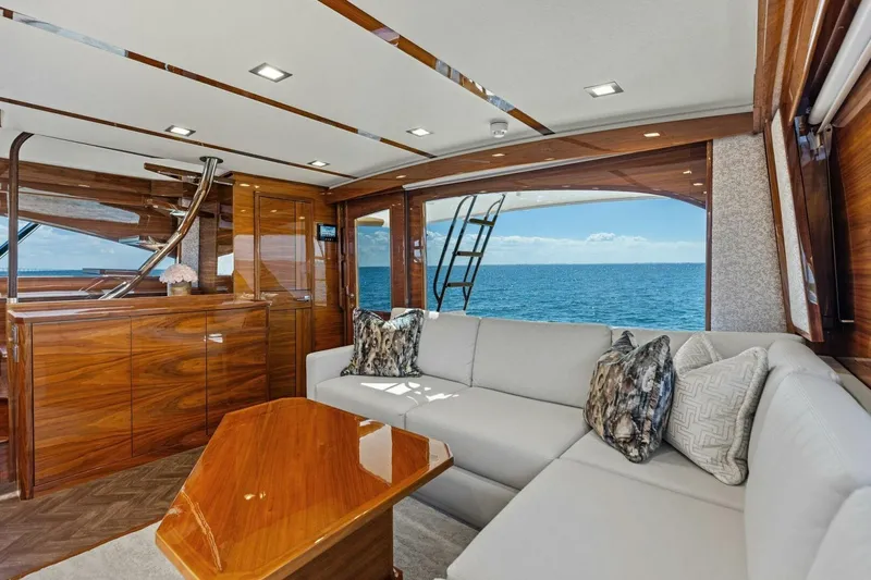Backlash Yacht Photos Pics Luxurious interior of 2023 Viking 72 Enclosed Bridge yacht with ocean view.