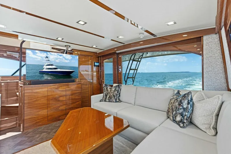 Backlash Yacht Photos Pics Luxurious interior of 2023 Viking 72 Enclosed Bridge yacht with ocean view.