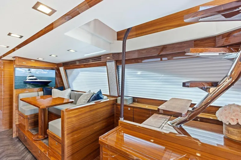 Backlash Yacht Photos Pics Luxurious interior of 2023 Viking 72 Enclosed Bridge yacht with elegant wood finishes.