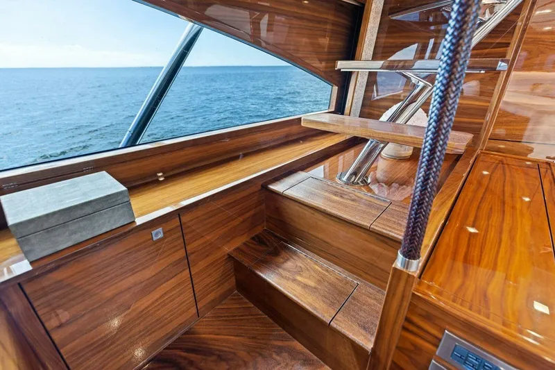 Backlash Yacht Photos Pics Luxurious interior of 2023 Viking 72 Enclosed Bridge yacht with ocean view.