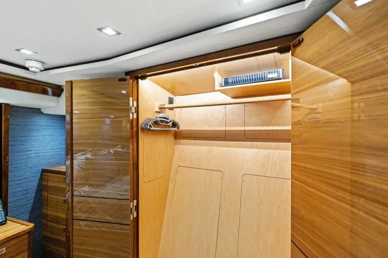 Backlash Yacht Photos Pics Luxurious wooden interior of 2023 Viking 72 Enclosed Bridge yacht cabin.