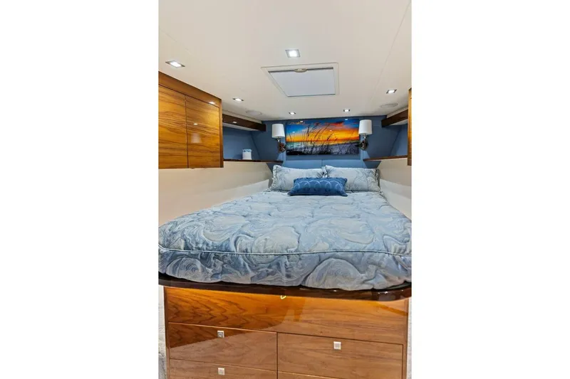 Backlash Yacht Photos Pics Luxurious bedroom interior of 2023 Viking 72 Enclosed Bridge yacht with elegant bedding.