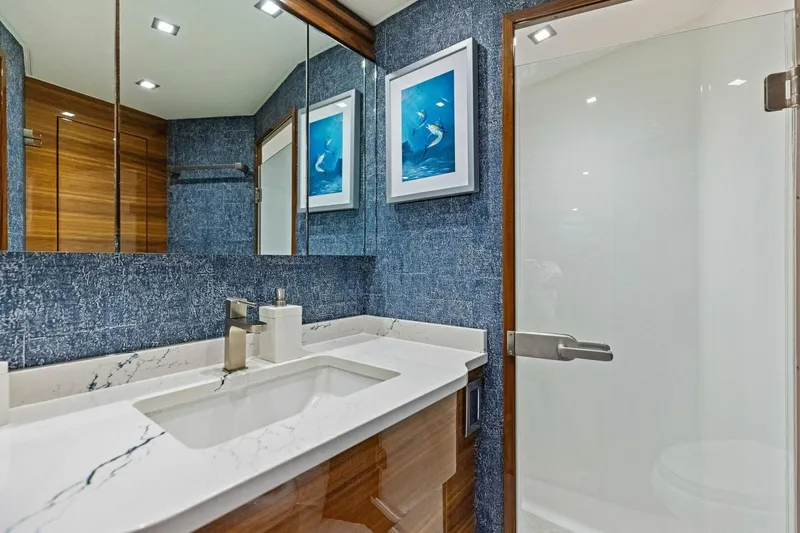 Backlash Yacht Photos Pics Luxurious bathroom in 2023 Viking 72 Enclosed Bridge yacht with modern fixtures and elegant decor.