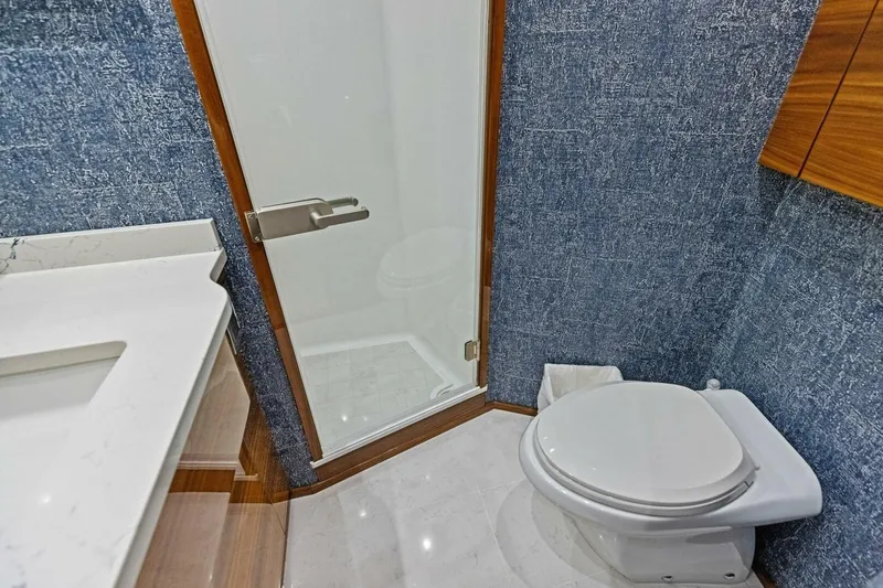 Backlash Yacht Photos Pics Luxurious bathroom in 2023 Viking 72 Enclosed Bridge yacht with modern fixtures.