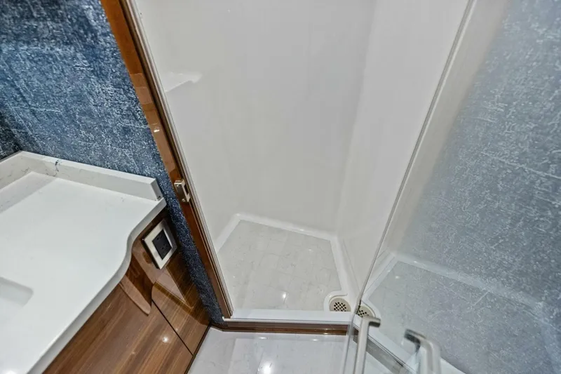 Backlash Yacht Photos Pics Luxurious bathroom shower in 2023 Viking 72 Enclosed Bridge yacht.