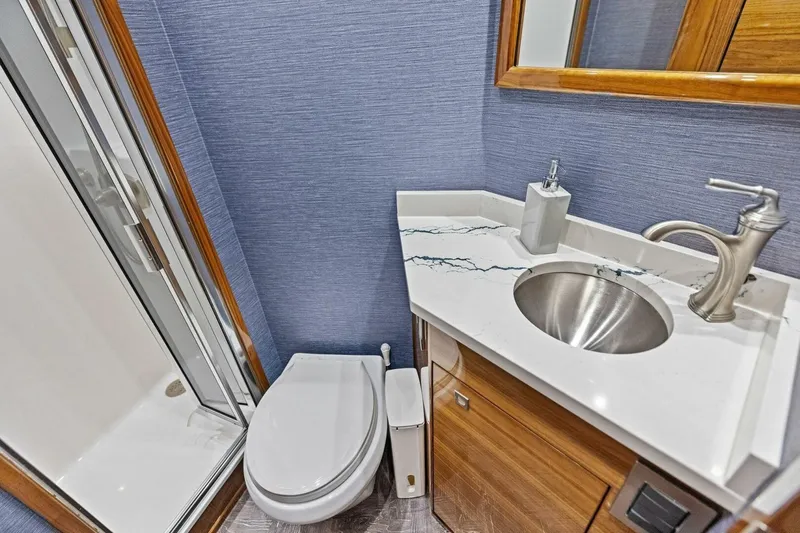 Backlash Yacht Photos Pics Luxurious bathroom in 2023 Viking 72 Enclosed Bridge yacht with modern fixtures and elegant design.