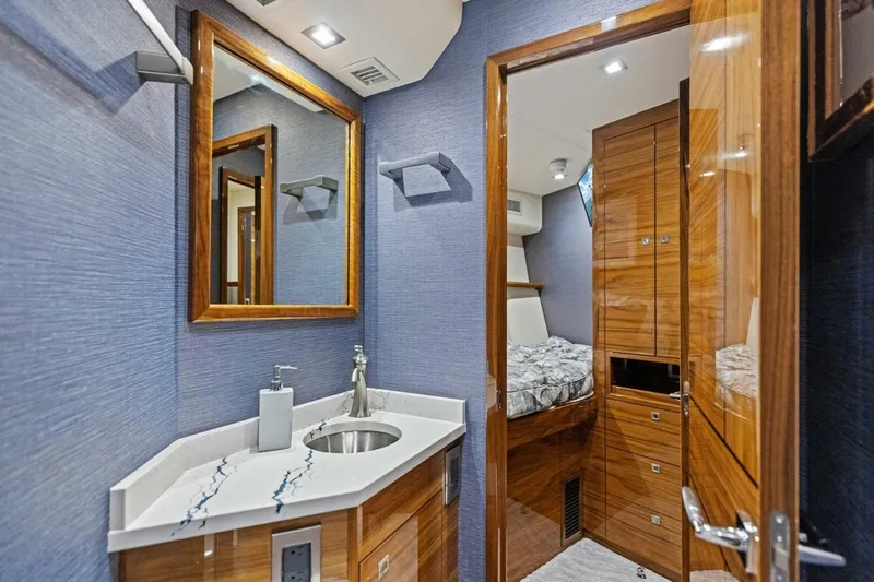 Backlash Yacht Photos Pics Luxurious bathroom interior of 2023 Viking 72 Enclosed Bridge yacht with modern fixtures.