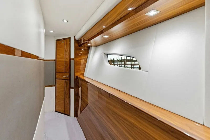 Backlash Yacht Photos Pics Luxurious interior of 2023 Viking 72 Enclosed Bridge yacht with sleek wood finishes.