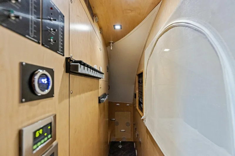 Backlash Yacht Photos Pics 2023 Viking 72 Enclosed Bridge interior with control panels and modern design.