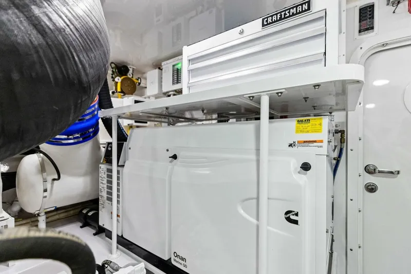 Backlash Yacht Photos Pics Engine room of 2023 Viking 72 Enclosed Bridge yacht with Craftsman toolbox and Onan generator.