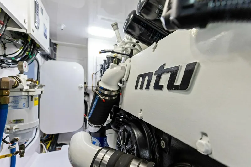 Backlash Yacht Photos Pics Engine room of 2023 Viking 72 Enclosed Bridge yacht with MTU engine components.