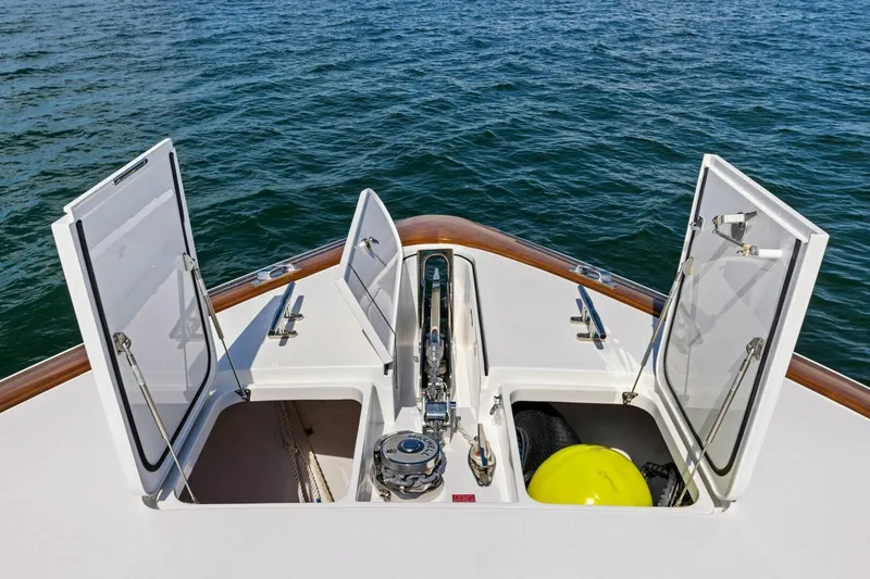 Backlash Yacht Photos Pics Bow storage compartments on 2023 Viking 72 Enclosed Bridge yacht, open on calm sea.