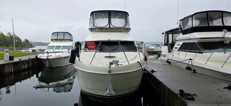  Yacht Photos Pics 2005 Meridian 368 Motor Yacht docked with other boats on a cloudy day.