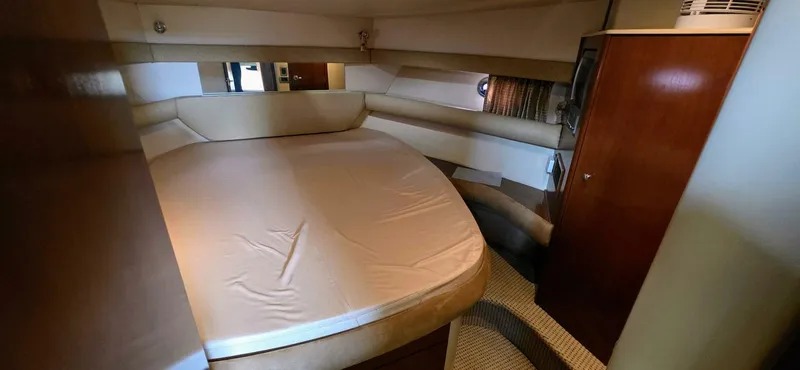 Yacht Photos Pics 2005 Meridian 368 Motor Yacht interior cabin with large bed and wooden cabinetry.