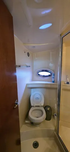  Yacht Photos Pics 2005 Meridian 368 Motor Yacht bathroom with toilet and porthole window.