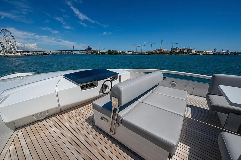 Scissortail II Yacht Photos Pics Luxurious 2013 Pershing 92 Express yacht deck with seating, overlooking scenic waterfront.