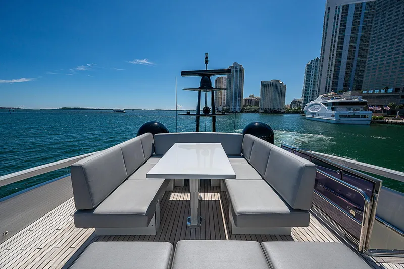 Scissortail II Yacht Photos Pics Luxurious seating area on a 2013 Pershing 92 Express yacht, with city skyline view.