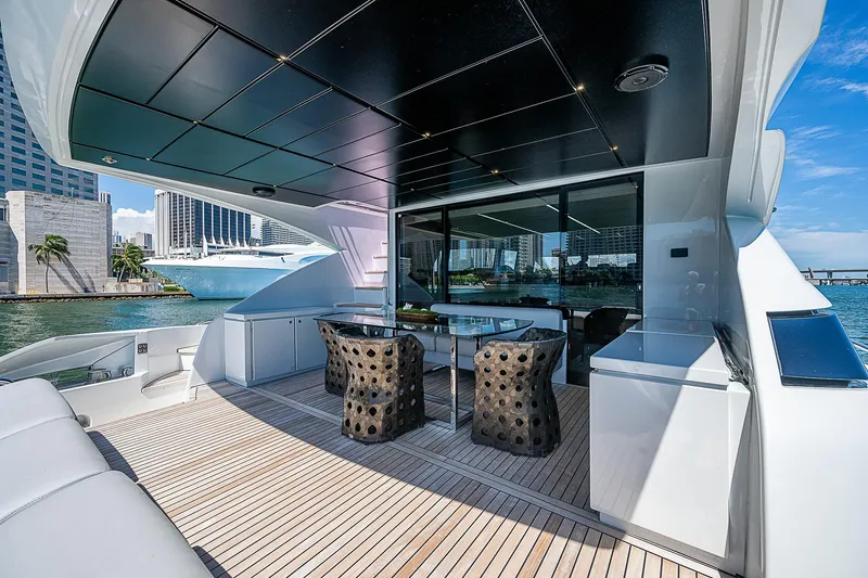 Scissortail II Yacht Photos Pics Luxurious 2013 Pershing 92 Express yacht deck with modern seating and cityscape view.