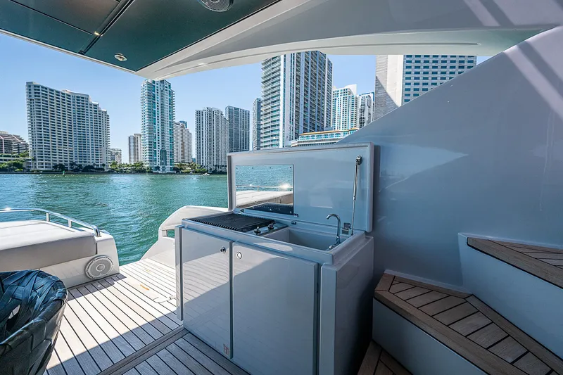 Scissortail II Yacht Photos Pics Luxury yacht deck with outdoor kitchen, city skyline view; 2013 Pershing 92 Express.