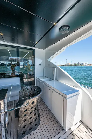 Scissortail II Yacht Photos Pics 2013 Pershing 92 Express yacht deck with modern seating and ocean view.