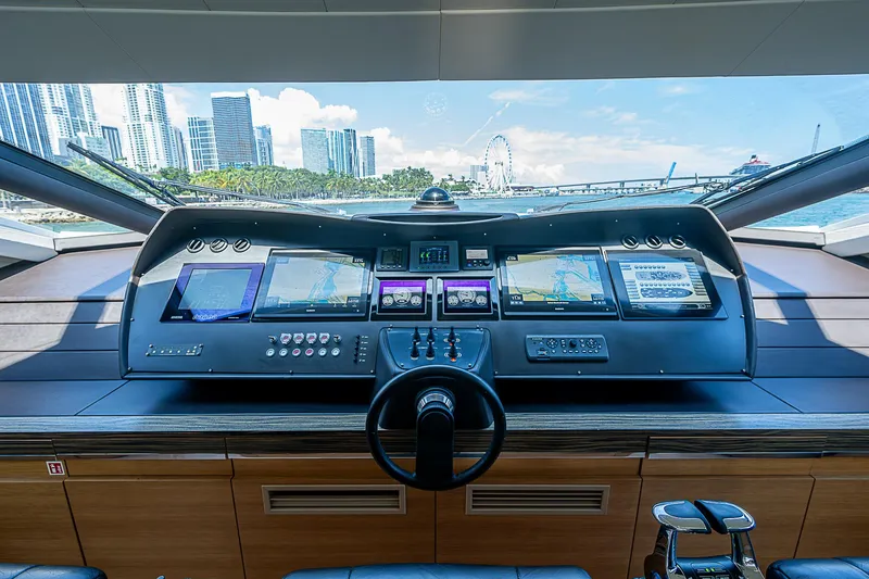 Scissortail II Yacht Photos Pics Control panel of 2013 Pershing 92 Express yacht with city skyline view.