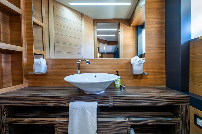 Scissortail II Yacht Photos Pics Luxurious bathroom interior of 2013 Pershing 92 Express yacht with modern sink and wood accents.