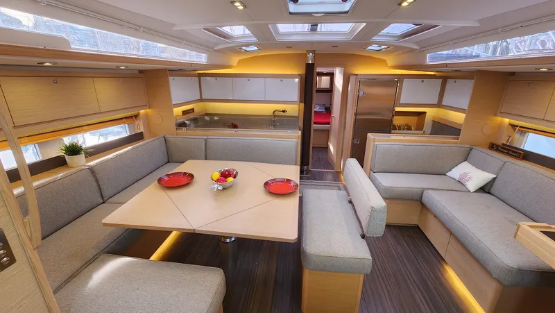 New Stock Boat - Available Now Yacht Photos Pics Luxurious interior of 2023 Dufour 530 yacht with modern seating and dining area.